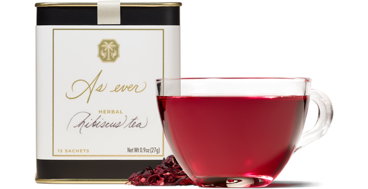 Cup of herbal hibiscus tea with tin