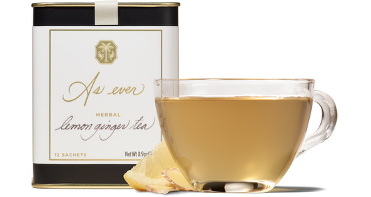 Cup of Herbal Lemon Ginger Tea with tin