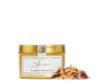 Gold tin of flower sprinkles with a decorative label, and loose flower sprinkles. 