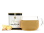 A tin of As ever tea, a clear glass of amber tea, and loose ginger and lemon slices. 