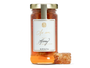 A jar of honey with a honeycomb. 