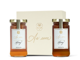 Two jars of honey in front of a beige decorative box labeled 'As ever' 