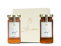 Two jars of honey in front of a beige decorative box labeled 'As ever' 
