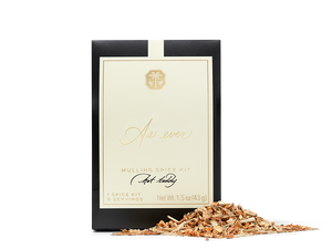 A black, beige, and gold package of mulling spice with loose spice in front of it. 