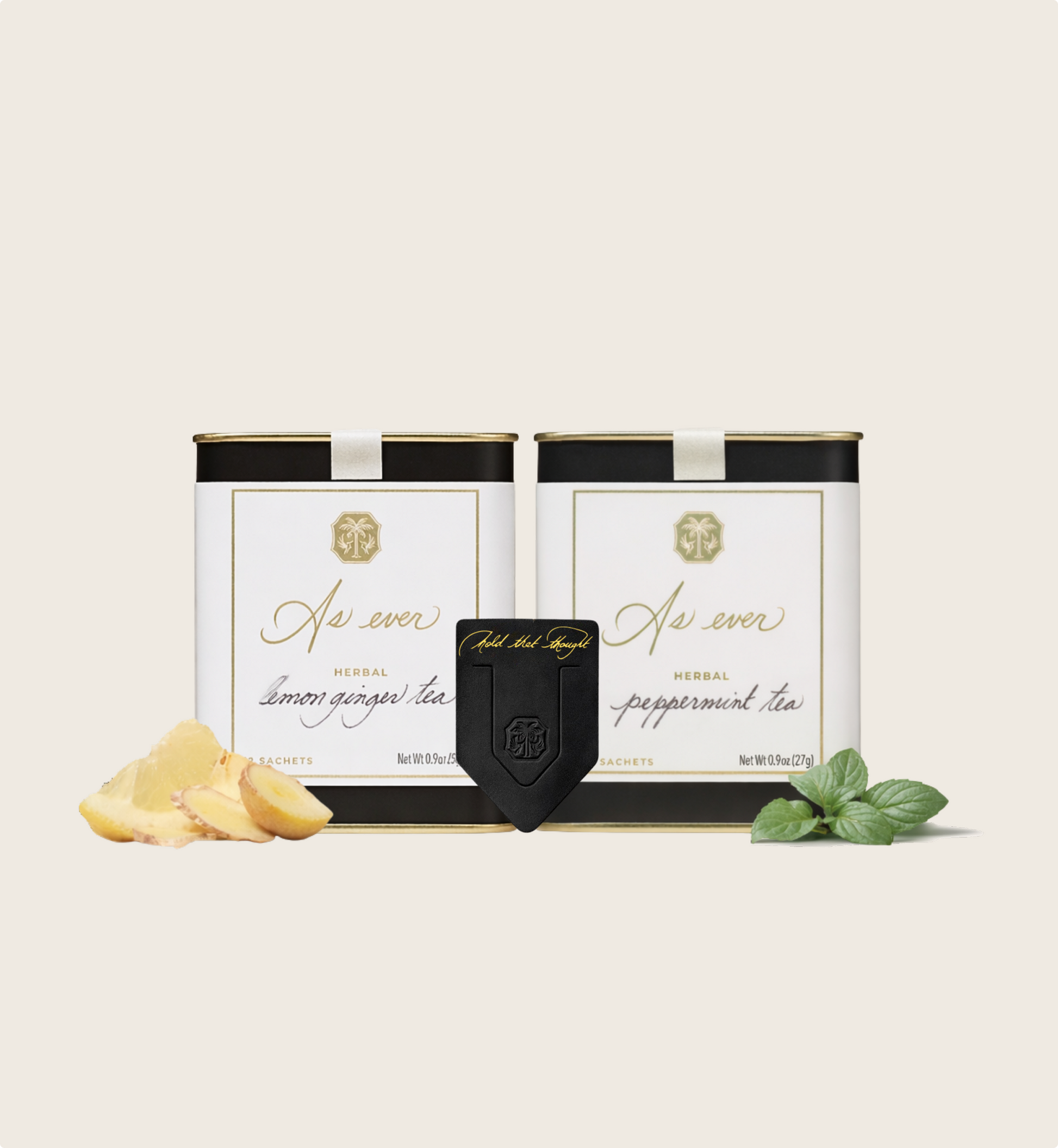Lemon Ginger Tea and Peppermint Tea Cannisters featured with a Black Leather bookmark on an off white background. 