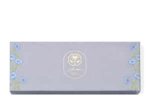 A blue chocolate box with blue flowers with green stems climbing the outside edges. A gold As ever logo is in the centre of the box. 