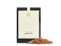 A black, beige, and gold package of mulling spice with loose spice in front of it. 