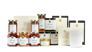 A variety of pantry products including candles, teas, honey, edible flower sprinkles, and jams and honeys. 