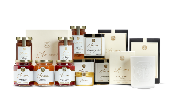 A variety of pantry products including candles, teas, honey, edible flower sprinkles, and jams and honeys. 