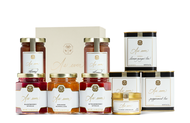 An assortment of pantry products including honeys, teas, jams, and flower sprinkles. 