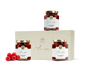 Three jars of raspberry spread, loose raspberries, and a beige box with a gold logo. 