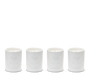 Four white candles in ceramic holders with embossed designs.