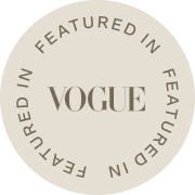 Round beige badge with 'Vogue' text on a white background